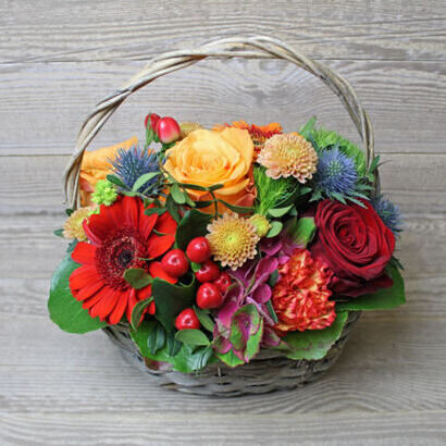 Flower arrangement in handle basket