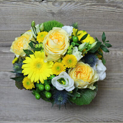 Yellow floral arrangement in basket