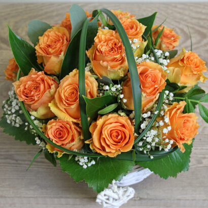 Orange rose arrangement in a basket