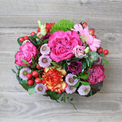 Pink floral arrangement in basket