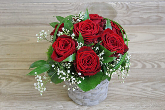 Small red rose arrangement in basket