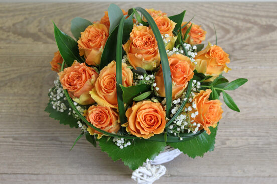 Orange rose arrangement in a basket