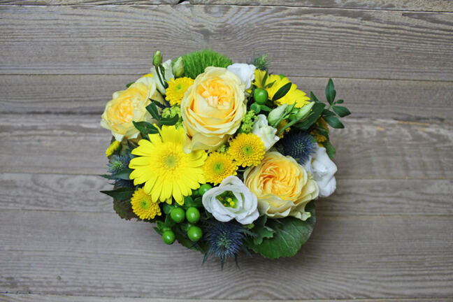 Yellow floral arrangement in basket