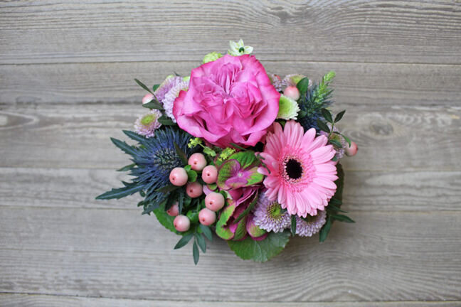 Small pink flower arrangement in the basket