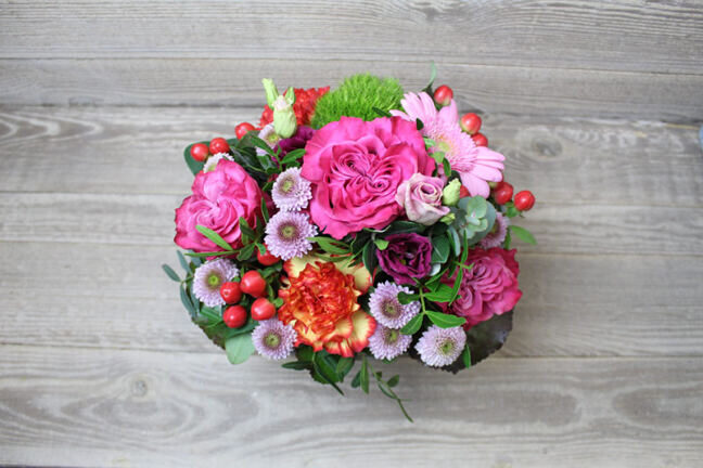 Pink floral arrangement in basket